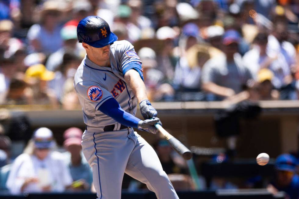 New York Mets' Mark Canha hits a pitch against the San Diego Padres in a baseball game Sunday, ...