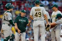 Oakland Athletics manager Mark Kotsay, second from left, comes to the mound to relieve Sam Long ...