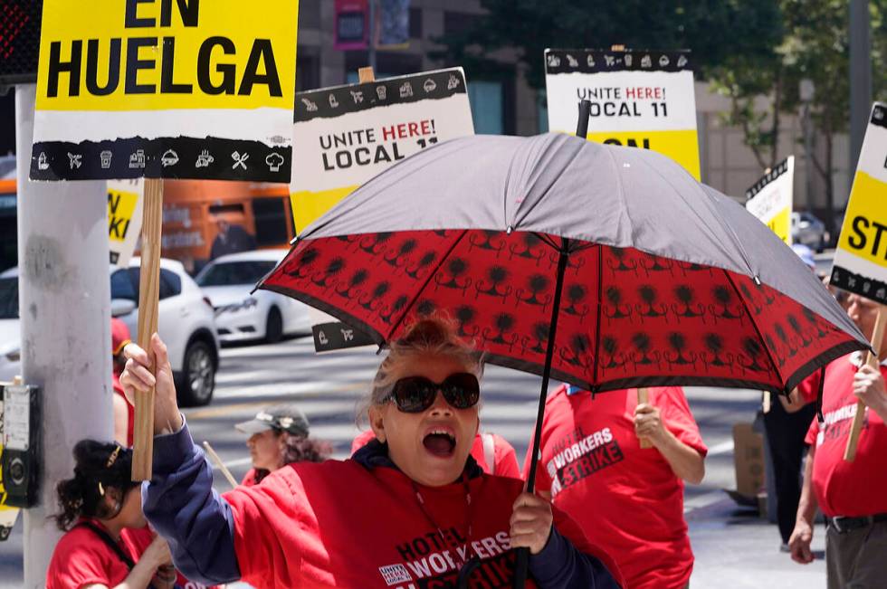 Striking hotel workers rally outside the InterContinental Los Angeles Downtown Hotel Tuesday, J ...