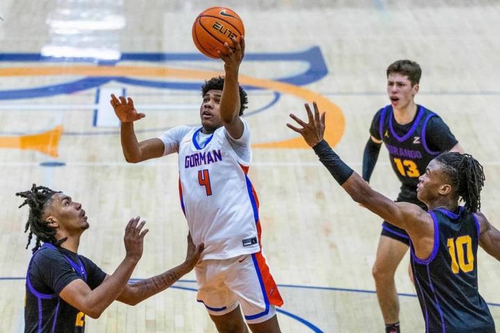 Bishop Gorman guard Jase Richardson (4) gets inside for a lay up over Durango guard Taj Degourv ...