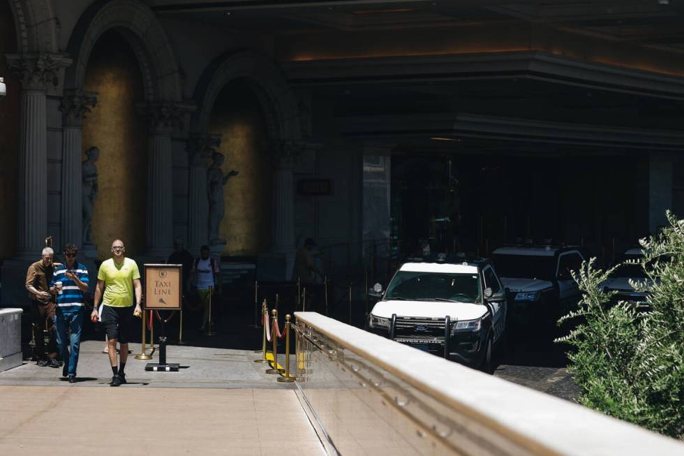 Tourists walk past a fleet of police cars on Tuesday, July 11, 2023, at Caesars Palace in Las V ...