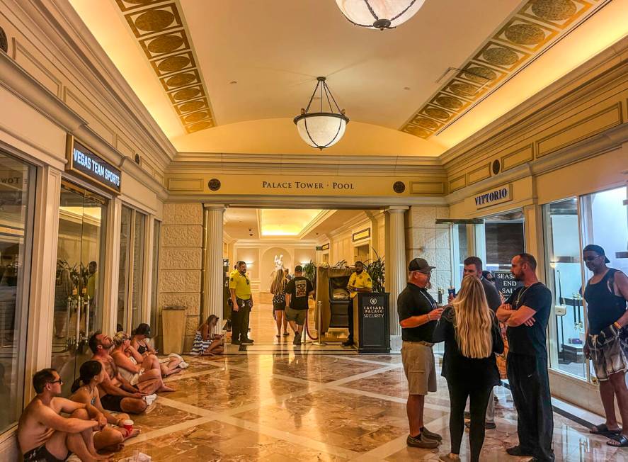 Security guards the entrance to a tower where a man is holding a woman hostage in a hotel room ...