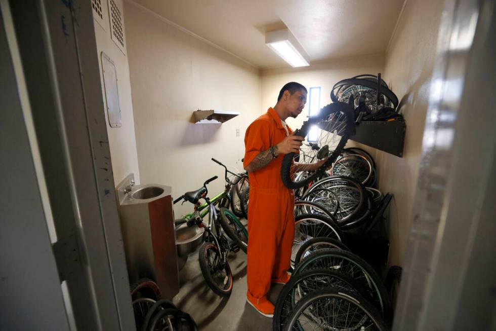 Inmate Alfredo Custodio checks a tire at a storage room for bikes at North Las Vegas Community ...