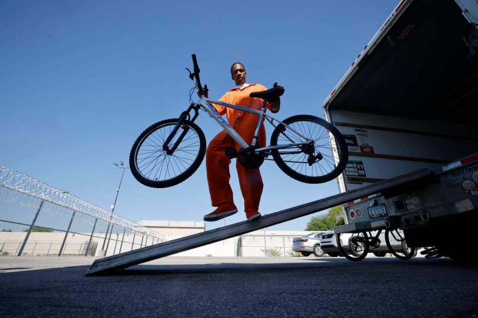 Inmate Ryan Brandon unloads a bike from a truck at North Las Vegas Community Correctional Cente ...