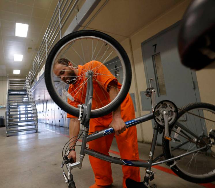 Inmate Jacquar Sprinkle carries a bike at North Las Vegas Community Correctional Center, Tuesda ...