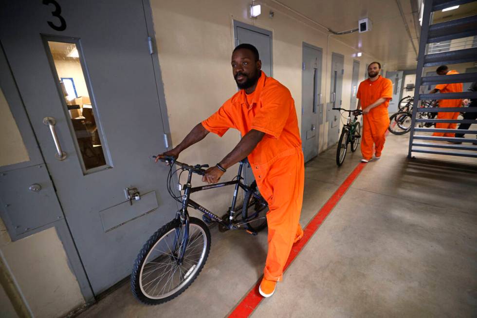 Inmates Omar Kemp, left, and Jacquar Sprinkle take bikes to load onto a truck for National Bike ...