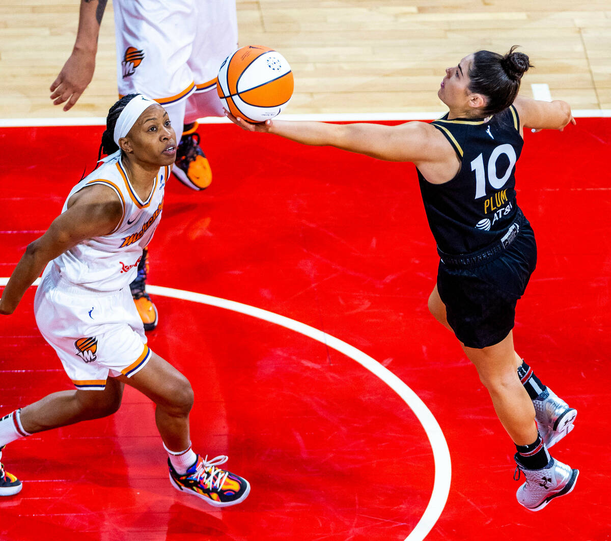 Las Vegas Aces guard Kelsey Plum (10) lays up the ball over Phoenix Mercury guard Shey Peddy (1 ...