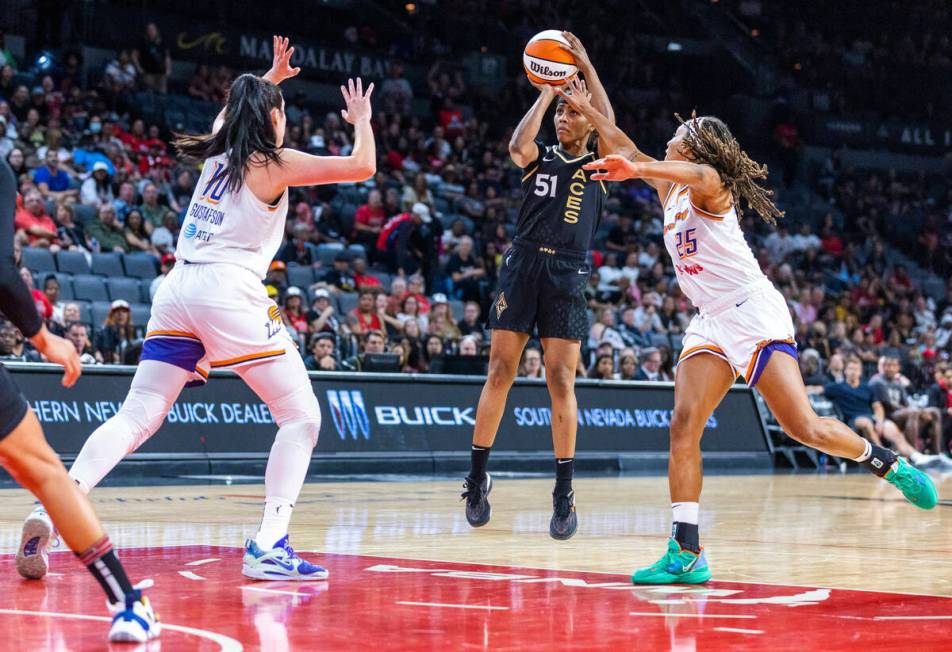 Las Vegas Aces guard Sydney Colson (51) gets off a jump shot over Phoenix Mercury guard Jennie ...