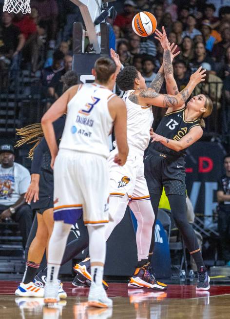 Aces forward Cayla George (13) rejects a shot attempt by Phoenix Mercury center Brittney Griner ...