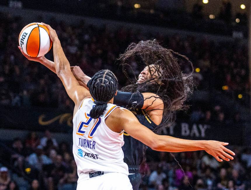 Aces forward A'ja Wilson (22) has the ball slapped by Phoenix Mercury forward Brianna Turner (2 ...