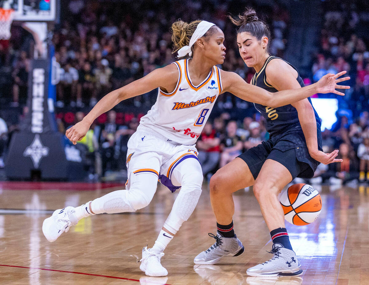 Aces guard Kelsey Plum (10) fakes out Phoenix Mercury guard Moriah Jefferson (8) with a behind- ...