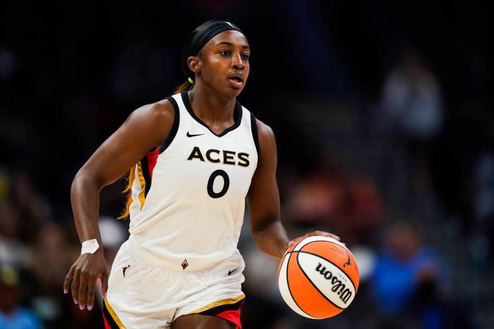 Las Vegas Aces guard Jackie Young brings the ball up during the first half of the team's WNBA b ...