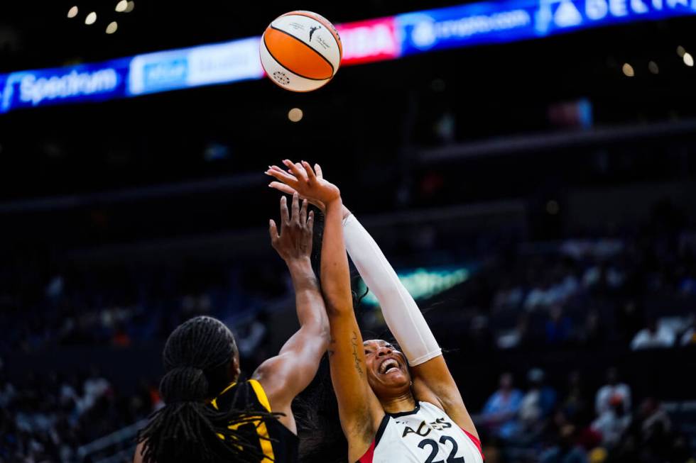 Las Vegas Aces forward A'ja Wilson (22) and Los Angeles Sparks forward Nneka Ogwumike (30) jump ...