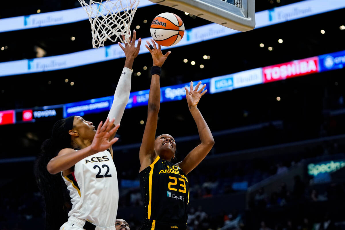 Los Angeles Sparks forward Azura Stevens (23) shoots against Las Vegas Aces forward A'ja Wilson ...