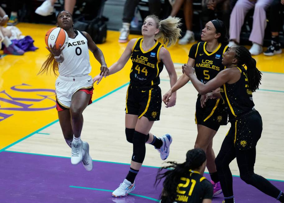 Las Vegas Aces guard Jackie Young (0) shoots during the first half of a WNBA basketball game in ...