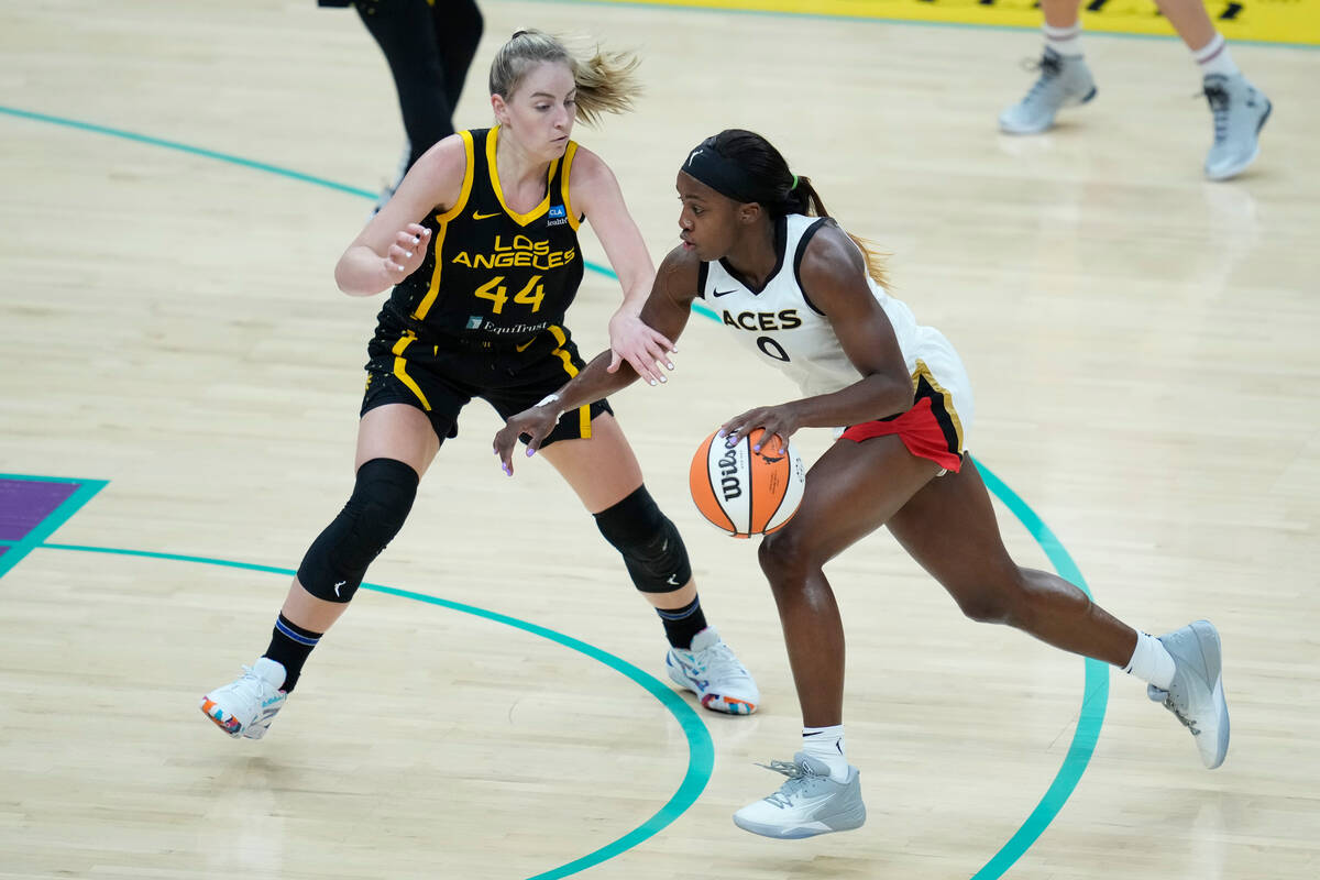 Las Vegas Aces guard Jackie Young (0) controls the ball against Los Angeles Sparks guard Karlie ...