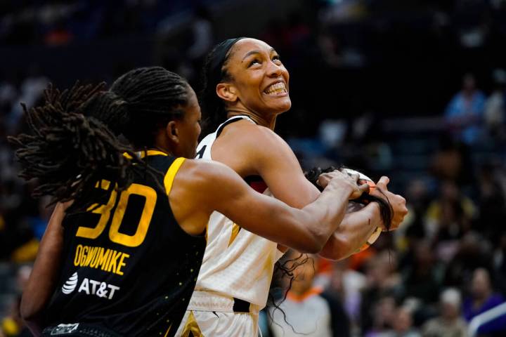 Las Vegas Aces forward A'ja Wilson tries to keep the ball from Los Angeles Sparks forward Nneka ...