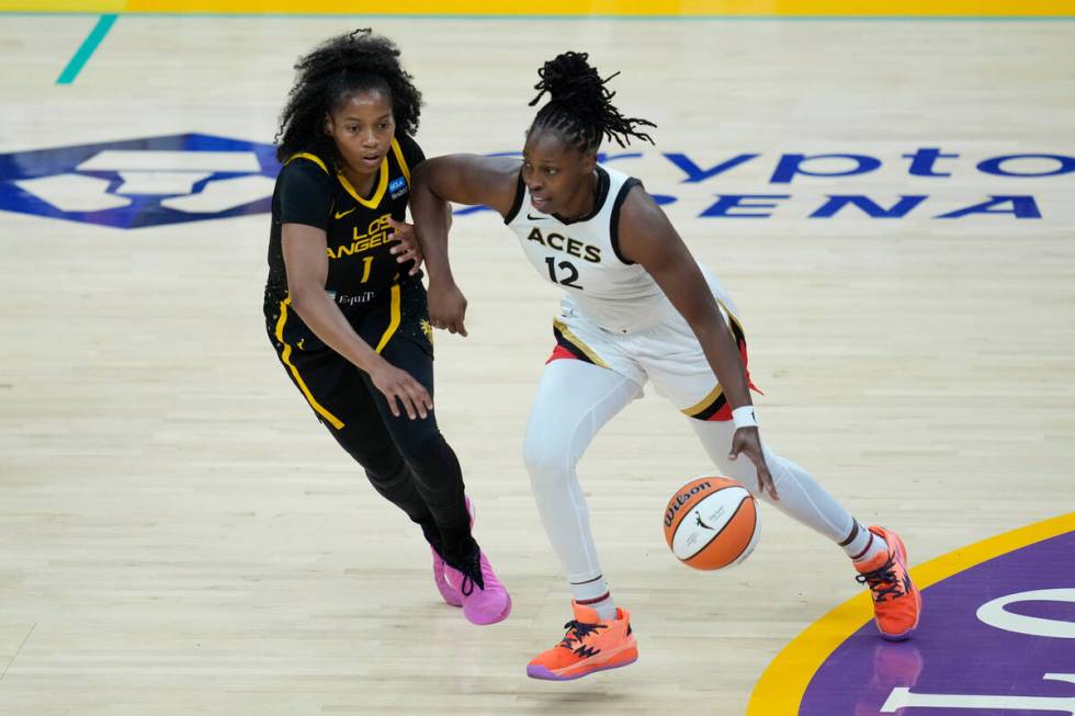 Las Vegas Aces guard Chelsea Gray (12) controls the ball against Los Angeles Sparks guard Zia C ...