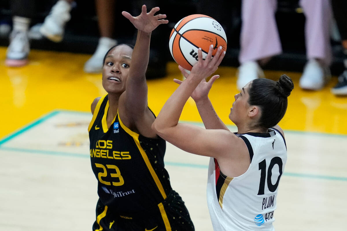 Los Angeles Sparks forward Azura Stevens (23) defends against Las Vegas Aces guard Kelsey Plum ...