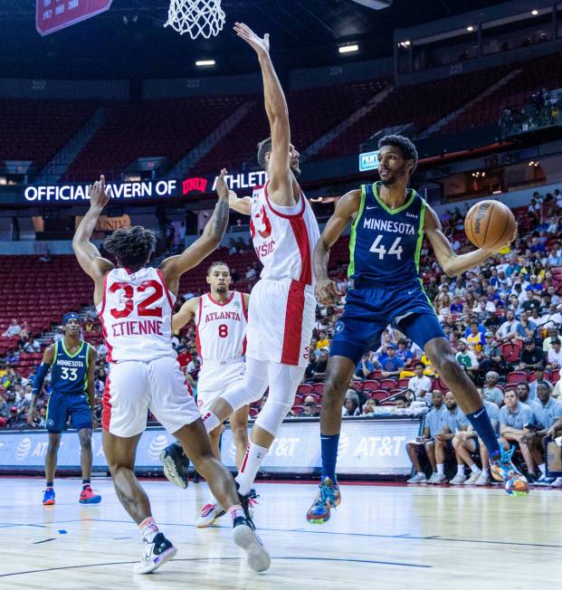 Minnesota Timberwolves forward Feron Hunt (44) looks to pass around Atlanta Hawks forward Uros ...