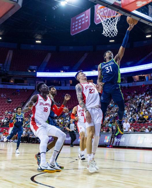 Minnesota Timberwolves guard Brandon Williams (31) lays in the ball over Atlanta Hawks forward ...