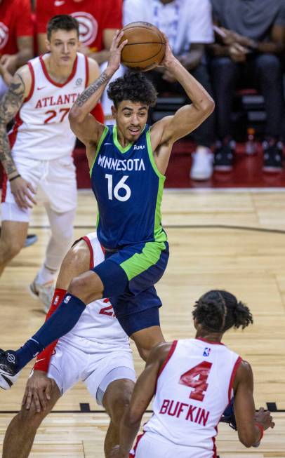 Minnesota Timberwolves guard D.J. Carton (16) looks tom pass over Atlanta Hawks guard Kobe Bufk ...