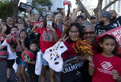 Fans watch as the Las Vegas Aces pass by during the team's WNBA Championship victory parade on ...