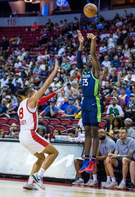 Minnesota Timberwolves forward Leonard Miller (33) shoots a 3-point basket over Atlanta Hawks g ...