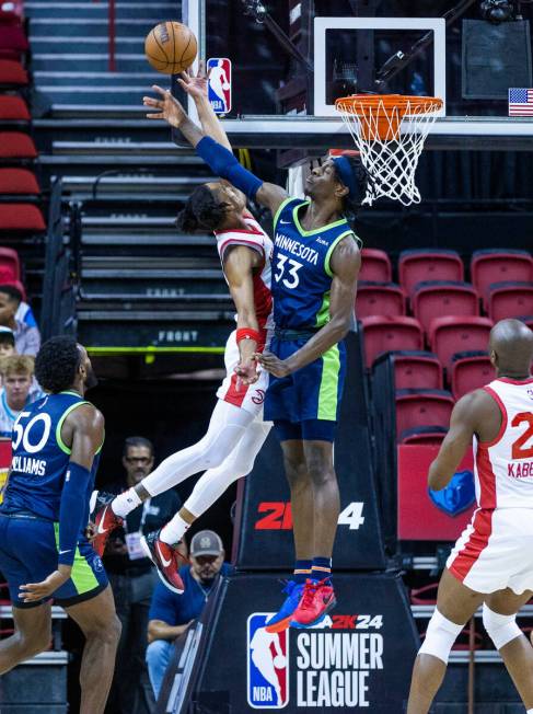 Minnesota Timberwolves forward Leonard Miller (33) rejects a shot attempt by Atlanta Hawks guar ...