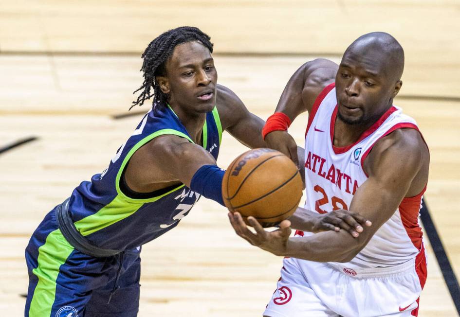 Minnesota Timberwolves forward Leonard Miller (33) grabs the arm of Atlanta Hawks forward Mfion ...