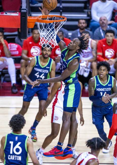 Minnesota Timberwolves forward Leonard Miller (33) scores over Atlanta Hawks forward Mfiondu Ka ...