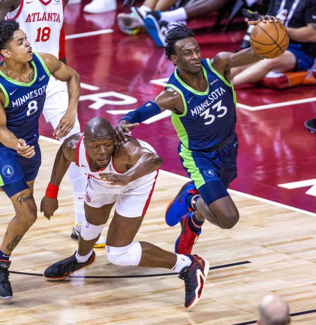 Minnesota Timberwolves forward Leonard Miller (33) grabs a rebound over Atlanta Hawks forward M ...