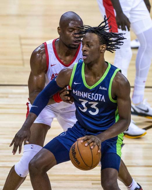 Minnesota Timberwolves forward Leonard Miller (33) works to drive the lane past Atlanta Hawks f ...