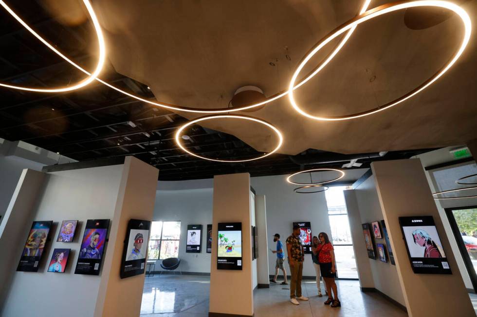 People look at NFT digital arts at JRNY Gallery, Friday, July 7, 2023, in Las Vegas. (Chitose S ...