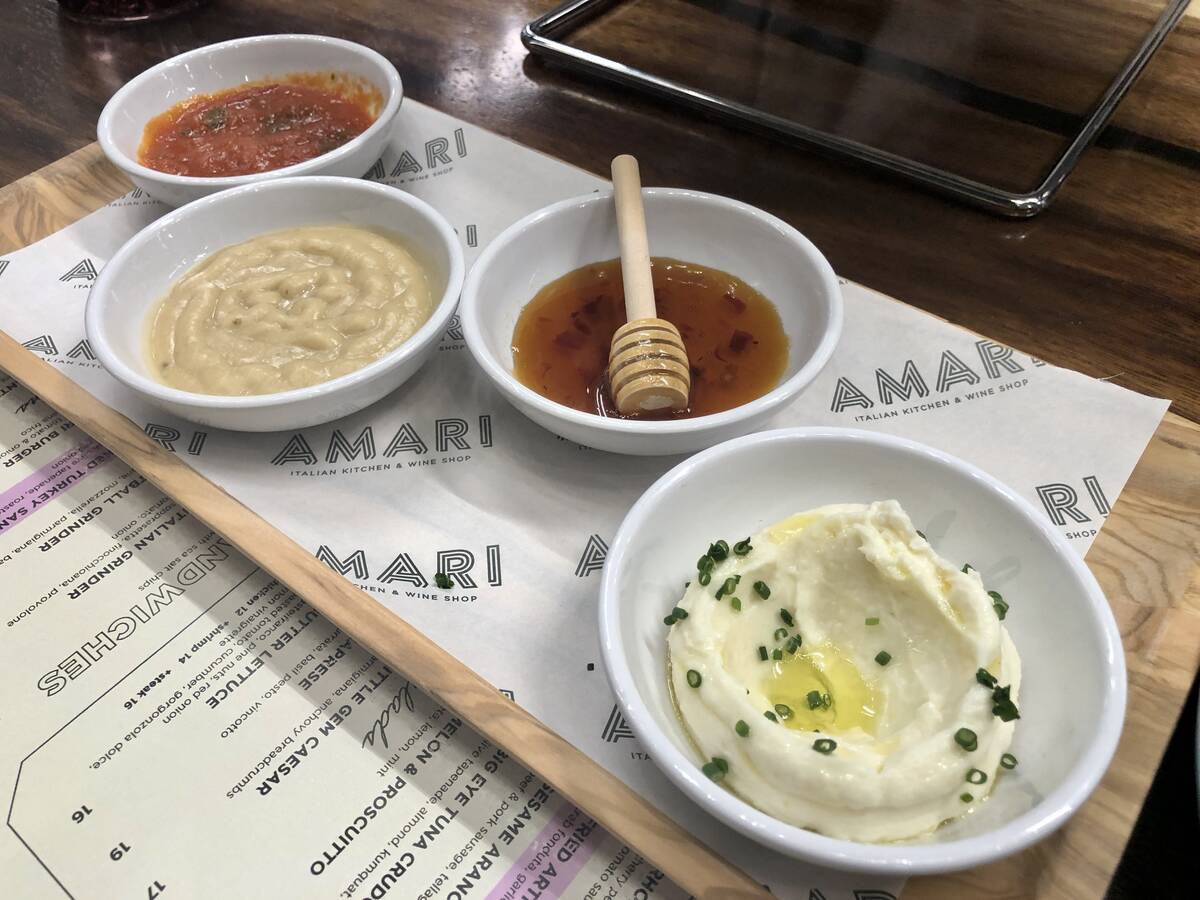 From left, traditional marinara, garlic crema, honey with Calabrian chilis and whipped ricotta, ...