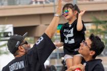 Mario Salazar high-fives his daughter Madyson Salazar, 5, who is carried by his son, Mario Sala ...