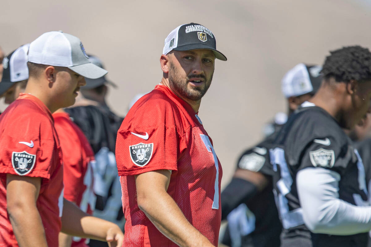 Raiders quarterback Brian Hoyer (7) dons a Vegas Golden Knights championship hat during an orga ...