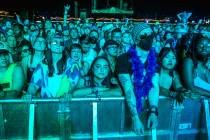 Fans listen while bathed in blue as Modest Mouse performs on the Downtown Stage during day two ...