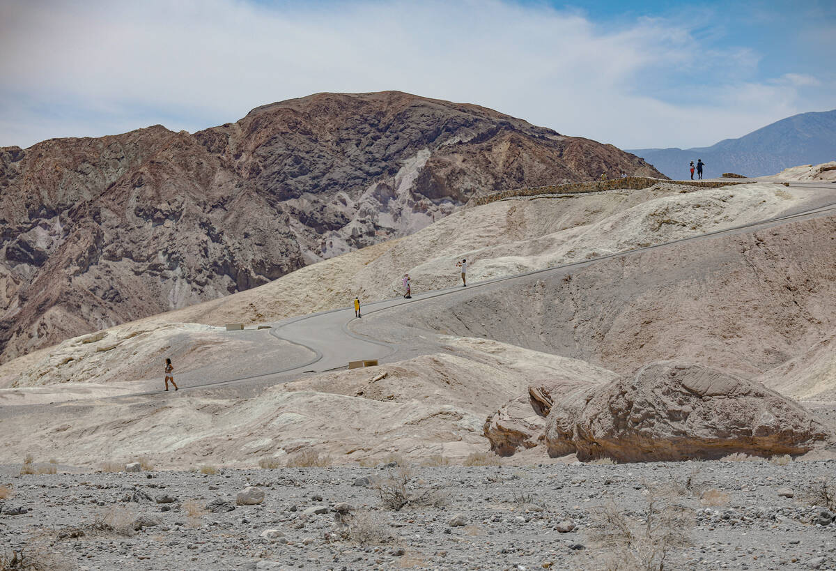 Visitors roam Zabriskie Point at Death Valley National Park in Calif., Sunday, July 16, 2023. ( ...