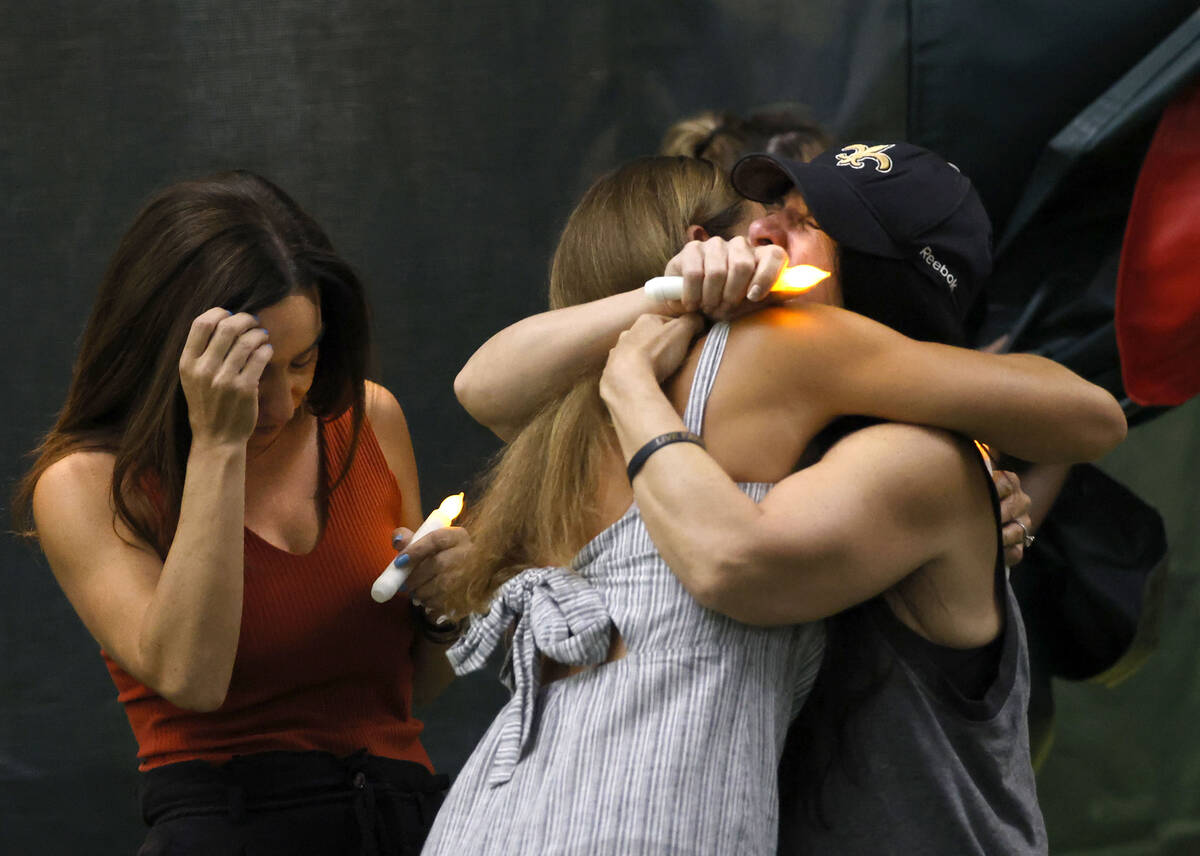 Brandon Farber’s mother Dawn, right, receives a hug during a candlelight vigil for Farber at ...