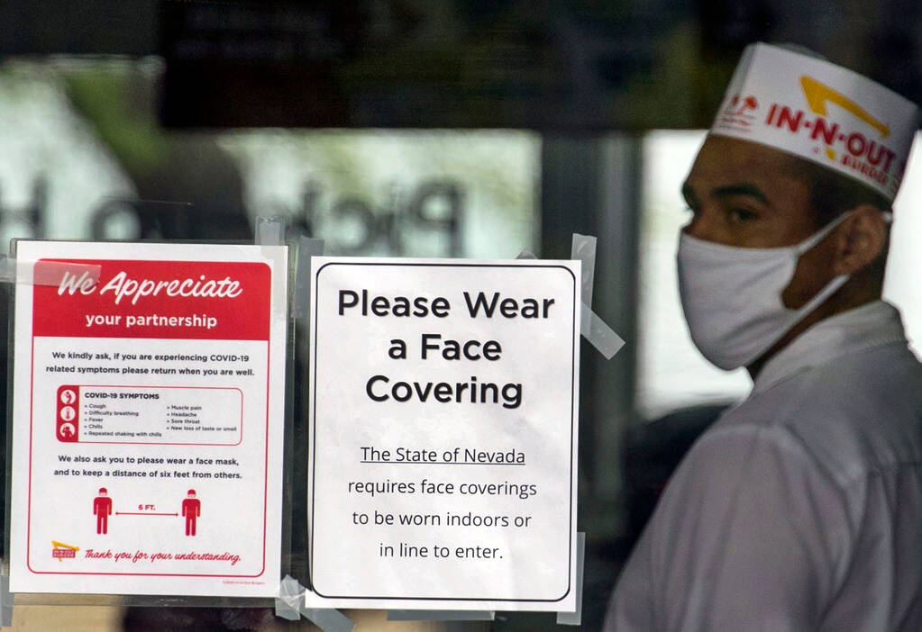 An In-N-Out Burger employee wears a face mask inside the restaurant on Friday, June 26, 2020, i ...