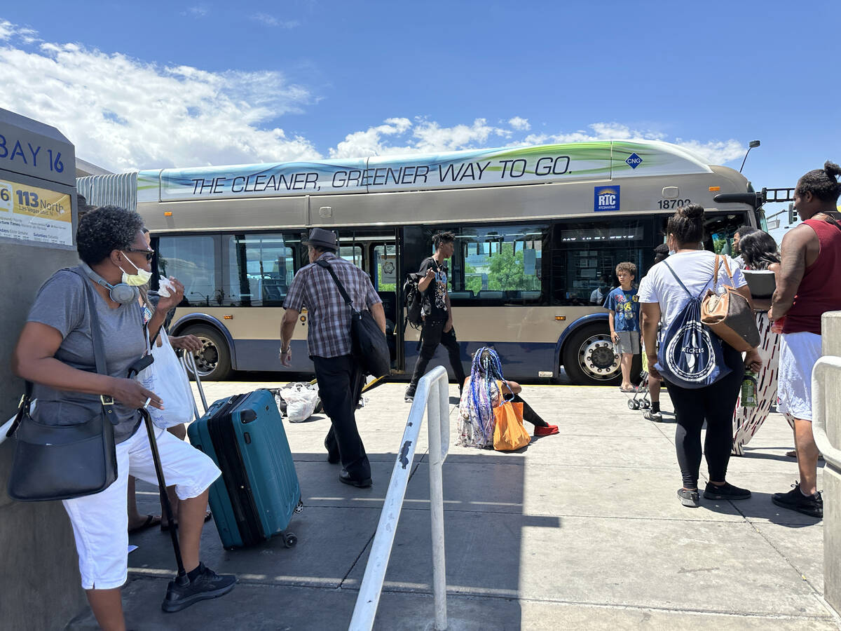 Bus riders prepare to board a Regional Transportation Commission bus at the Bonneville Transit ...