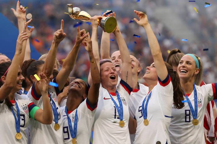 FILE - United States' Megan Rapinoe holds the trophy celebrating at the end of the Women's Worl ...