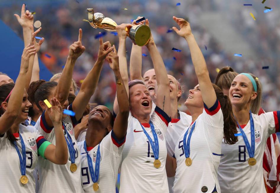 FILE - United States' Megan Rapinoe holds the trophy celebrating at the end of the Women's Worl ...