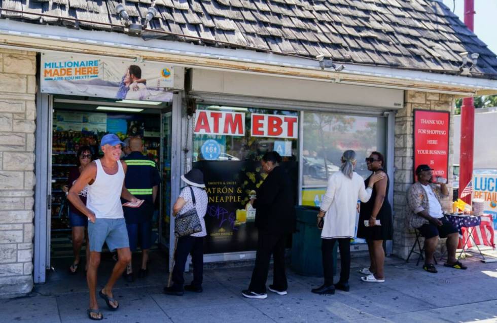 People wait in line to purchase lottery tickets, Wednesday, July 19, 2023, in Hawthorne, Calif. ...