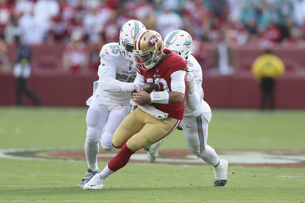 San Francisco 49ers quarterback Jimmy Garoppolo (10) is tackled by Miami Dolphins linebacker Je ...