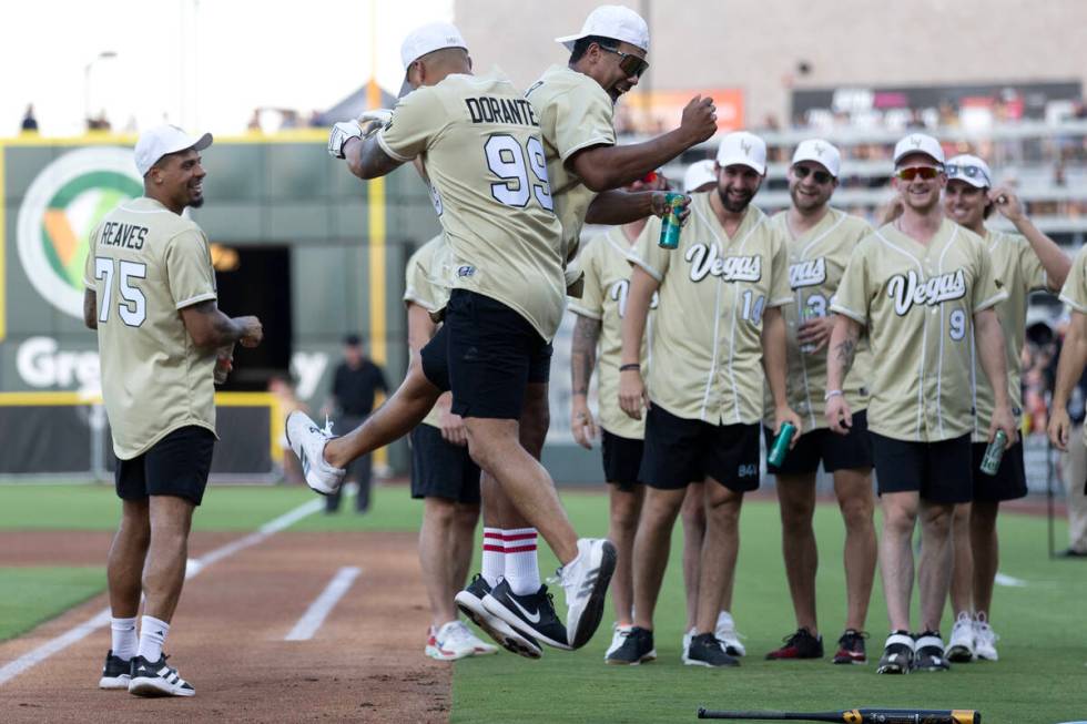 Golden Knights manual therapist Raul Dorantes (99) celebrates with defenseman Keegan Kolesar af ...