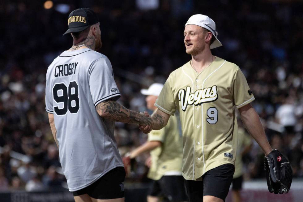 Raiders defensive end Maxx Crosby shakes hands with Golden Knights center Jack Eichel during th ...