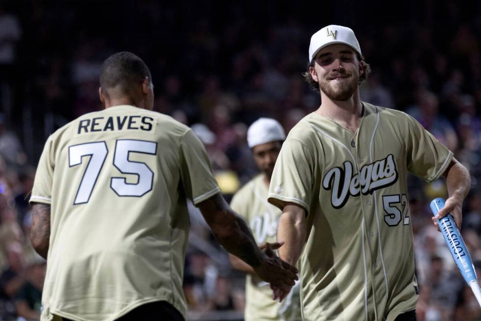 Former Golden Knights Ryan Reaves and Dylan Coghlan slap hands during the annual Battle for Veg ...