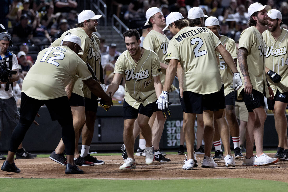 Former Golden Knight and event organizer Reilly Smith celebrates after scoring a home run durin ...